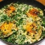 chicken thighs and creamed spinach in a pan after roasting