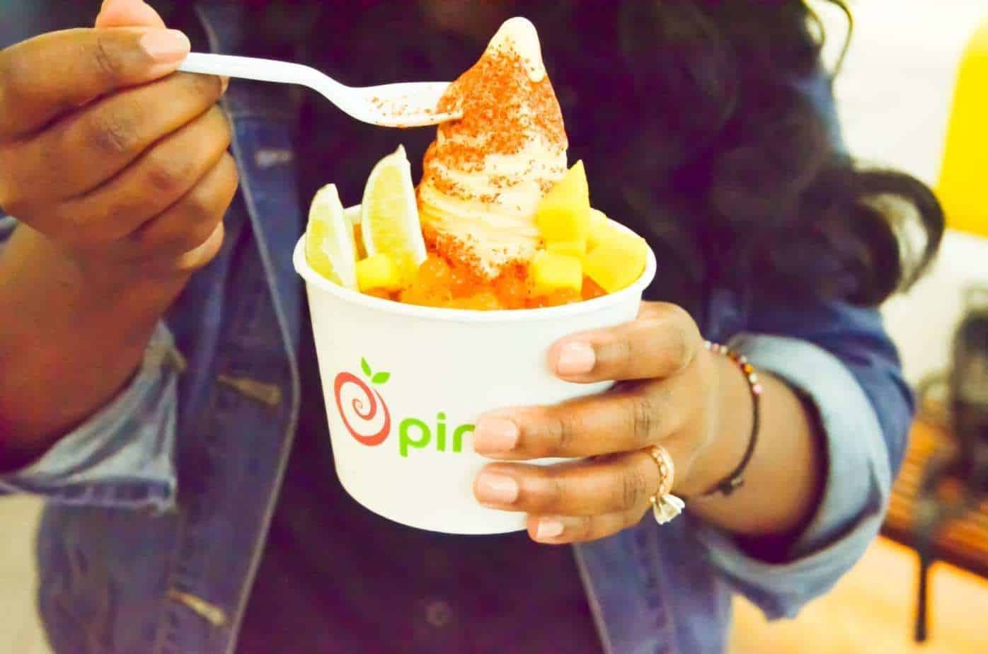 Mila holding pinkberry's mango tajin fro-yo