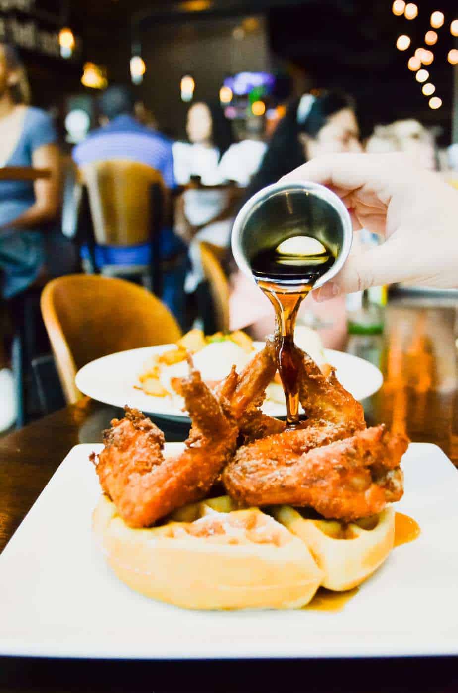 Fried chicken with syrup poured over at Max's Wine Dive