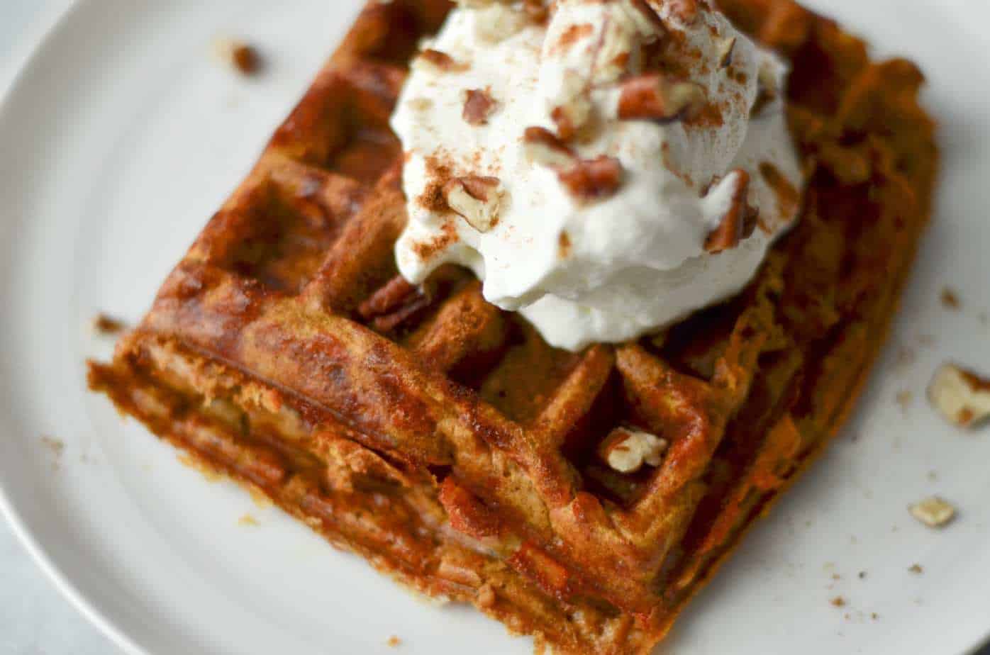 Pumpkin pie chaffle with whipped cream and pecans on top