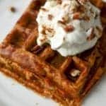 Pumpkin pie chaffle with whipped cream and pecans on top