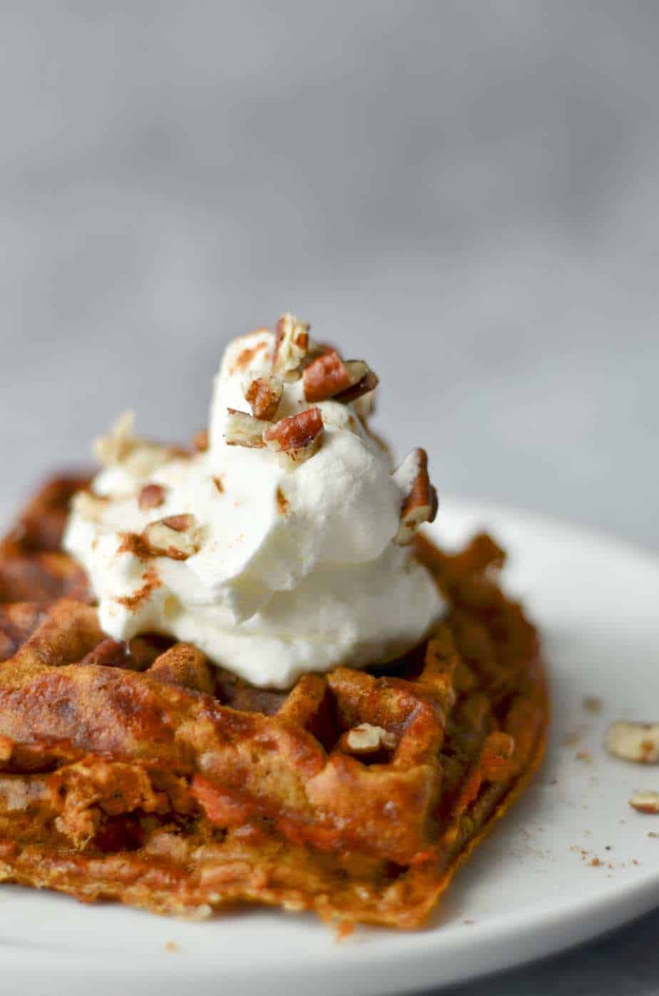 Pumpkin pie chaffle with whipped cream and pecans on top