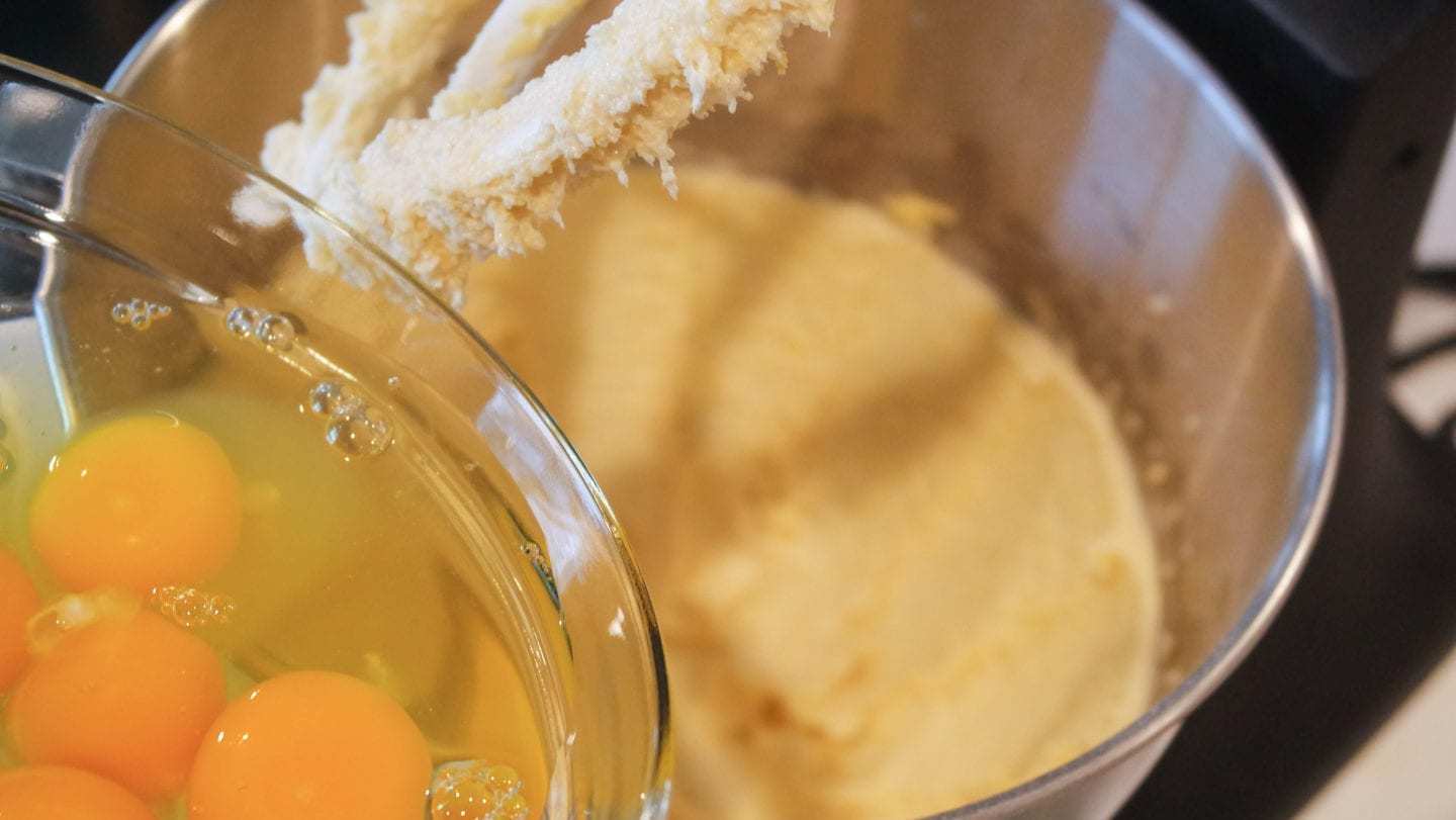Adding eggs to the pound cake batter