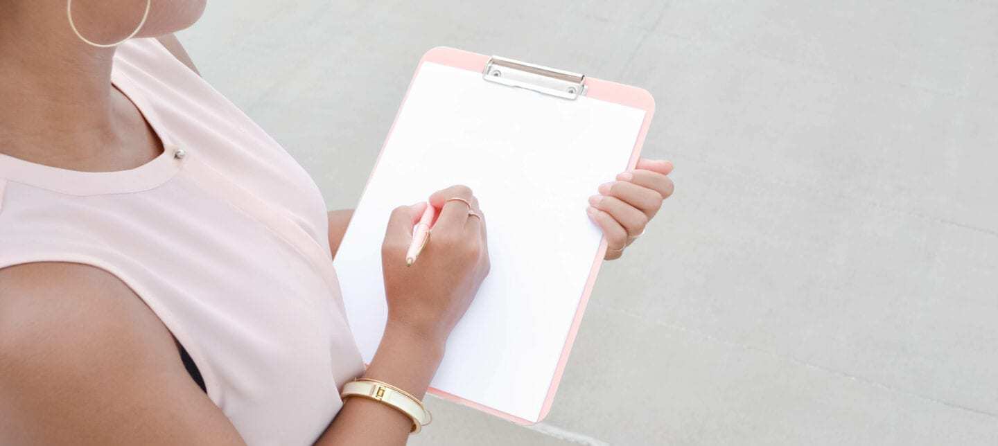 woman holding a clipboard
