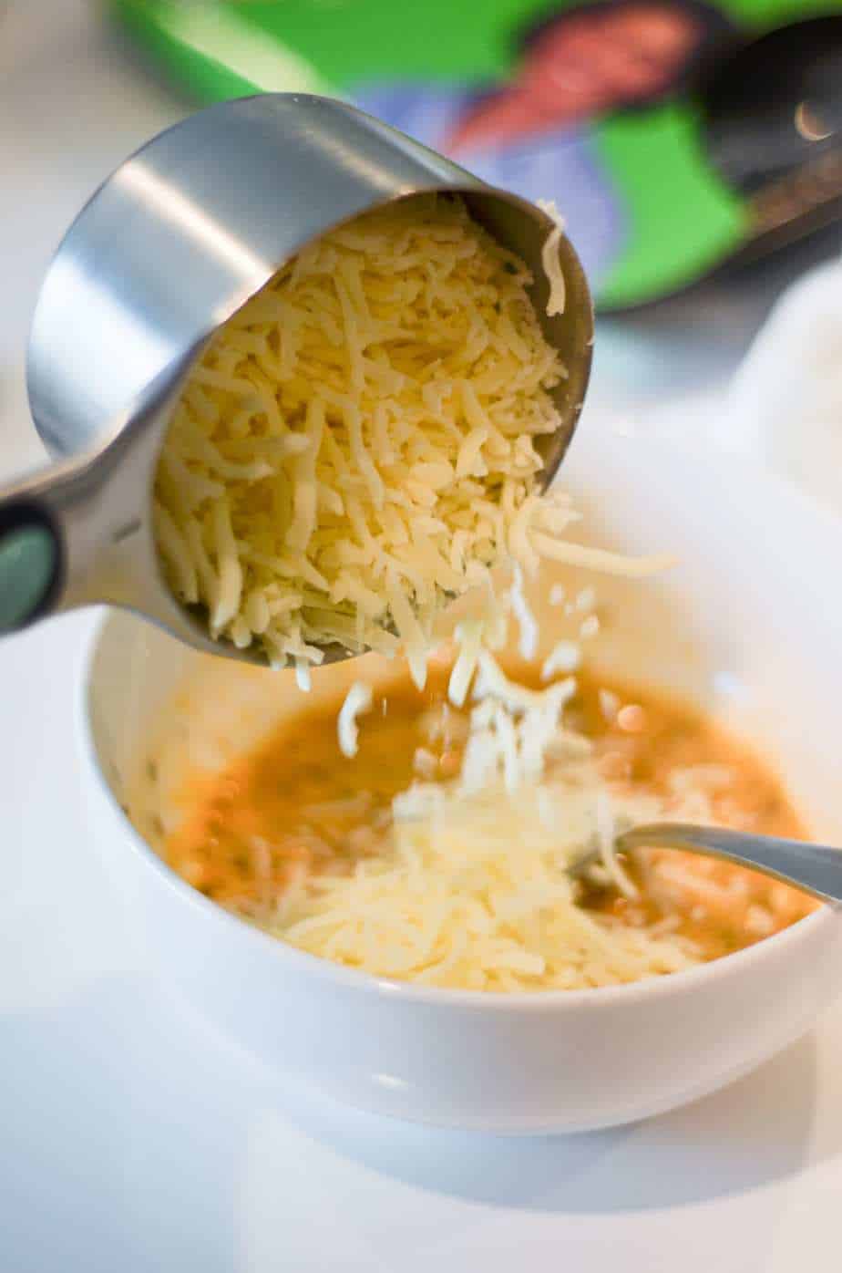 Adding mozzarella to bowl to make a chaffle recipe