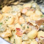 gnocchi pasta in pan with sauce, bacon and basil