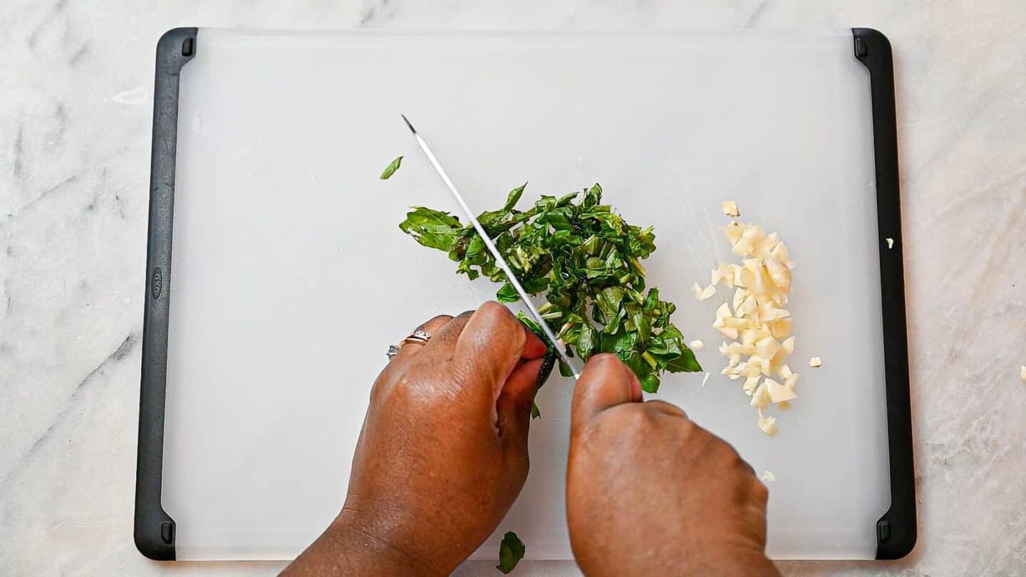 Chopping garlic and basil