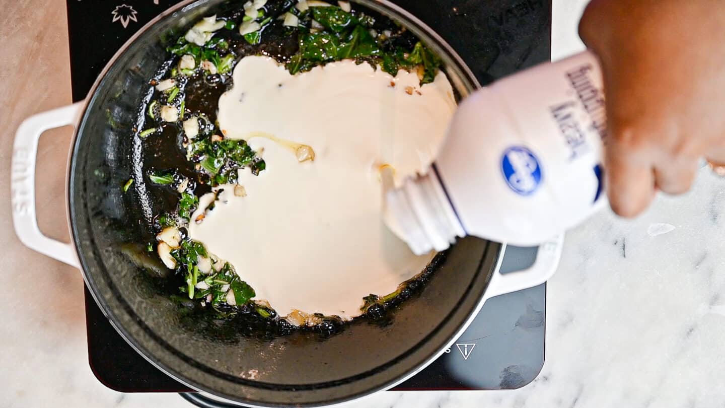 pouring heavy cream into pan