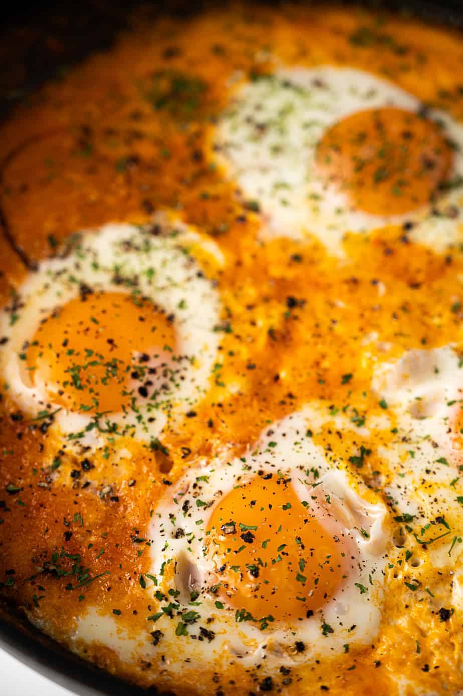 Eggs with parsley in a shakshuka