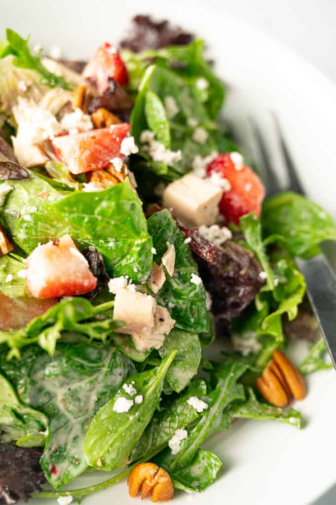 Lettuce with chicken strawberries pecans and goat cheese