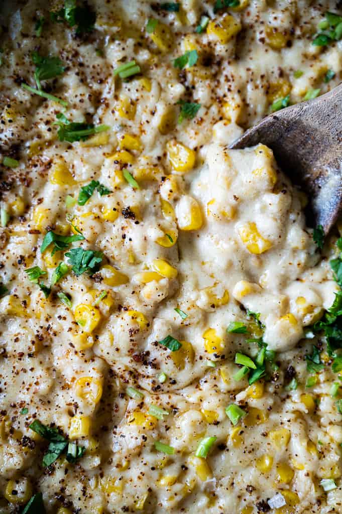 Elote in pan with a spoon