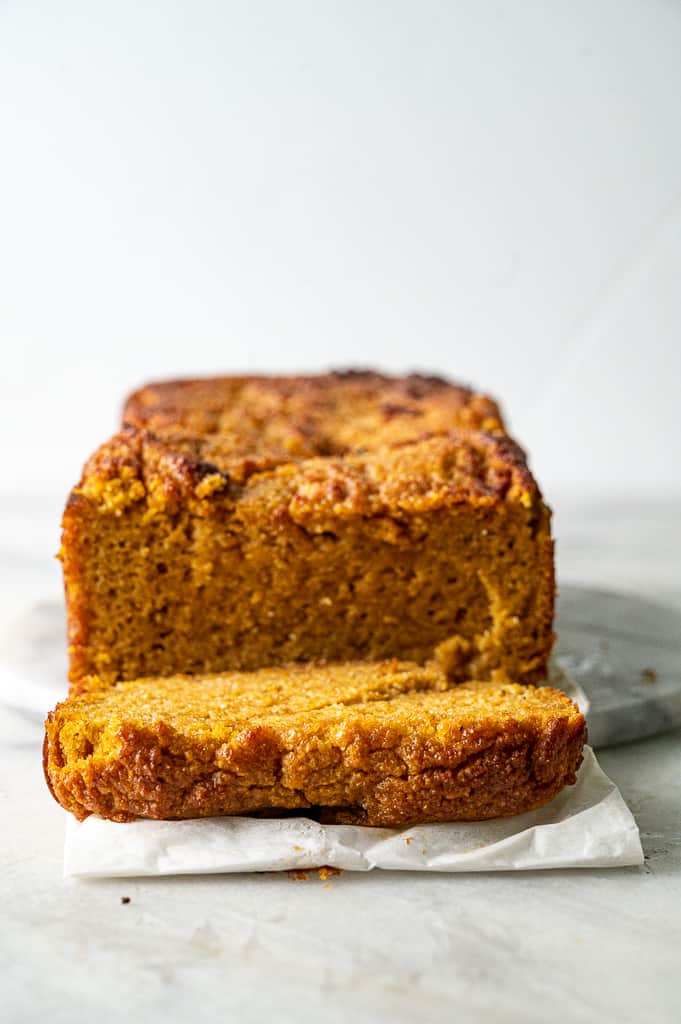 Keto pumpkin bread from the front, on top of parchment paper. 