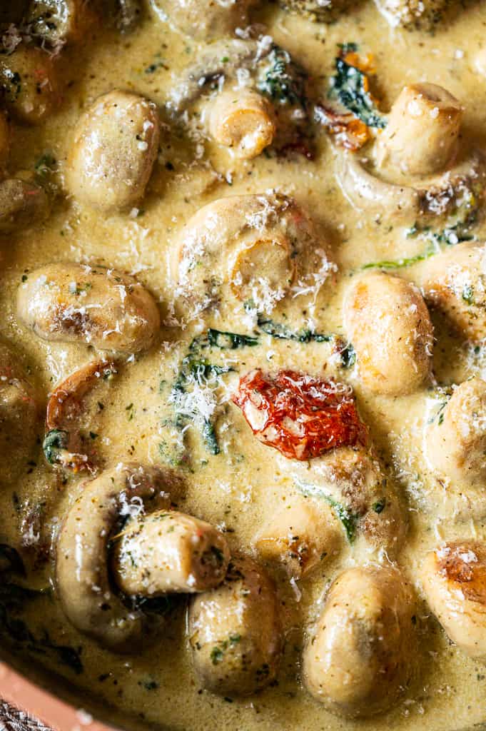 Garlic butter mushrooms, spinach, sun dried tomato in a pan