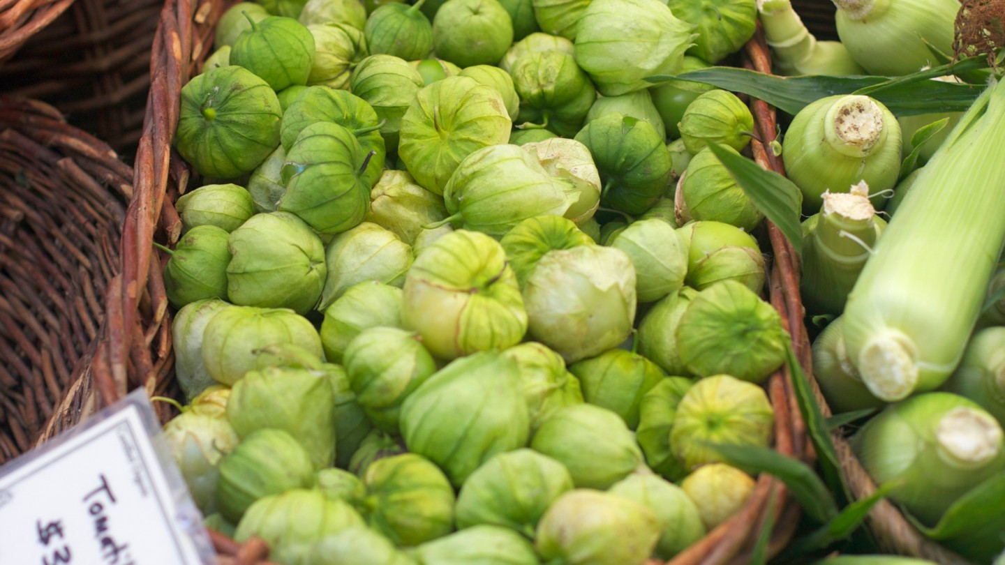 Tomatillos in a basket at a market