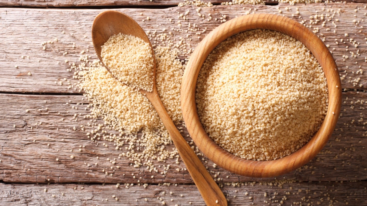 couscous in a bowl and scooped out of the bowl with a spoon.
