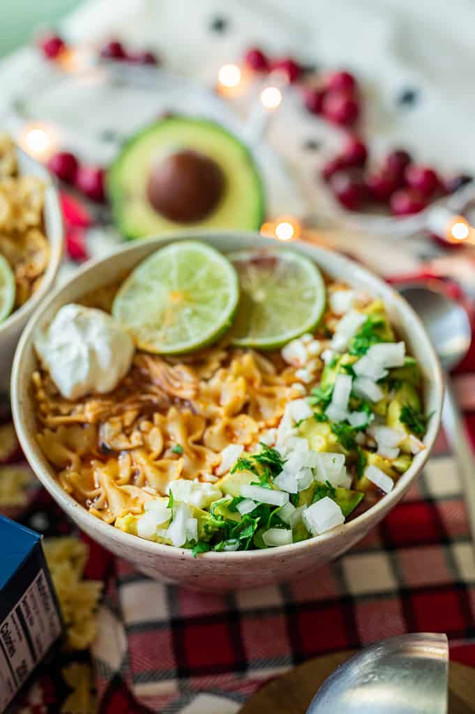 Chicken enchilada soup on table with spoon and ladle