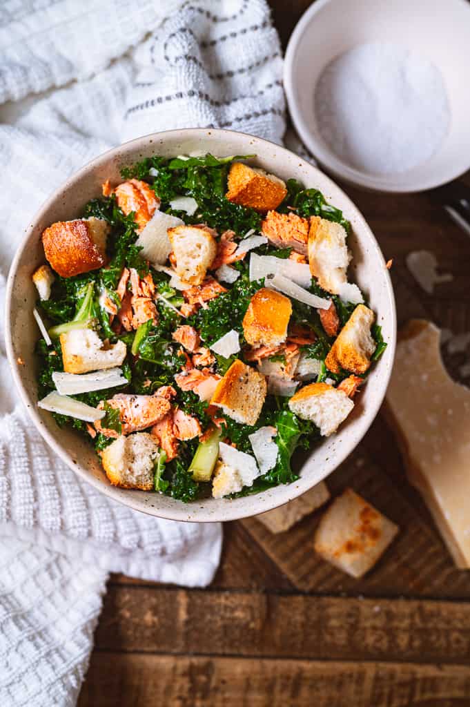 salmon caesar salad with parmigiano reggiano grated over the top.