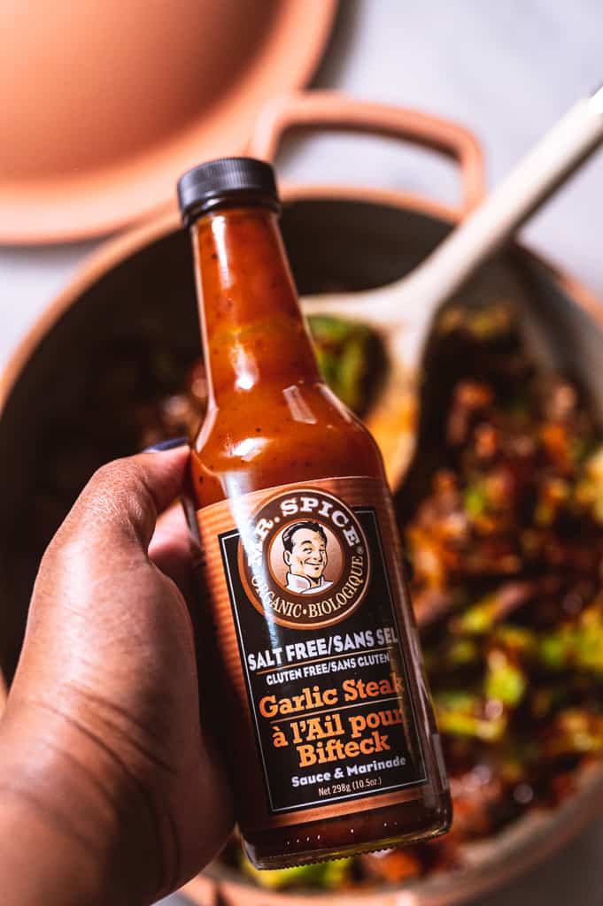 Mr. Spice Garlic Steak Sauce Bottle held in hand