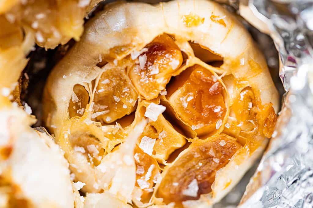close up photo of roasted garlic with salt