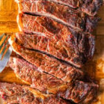 Ancho Chile Rubbed steak on a cutting board.