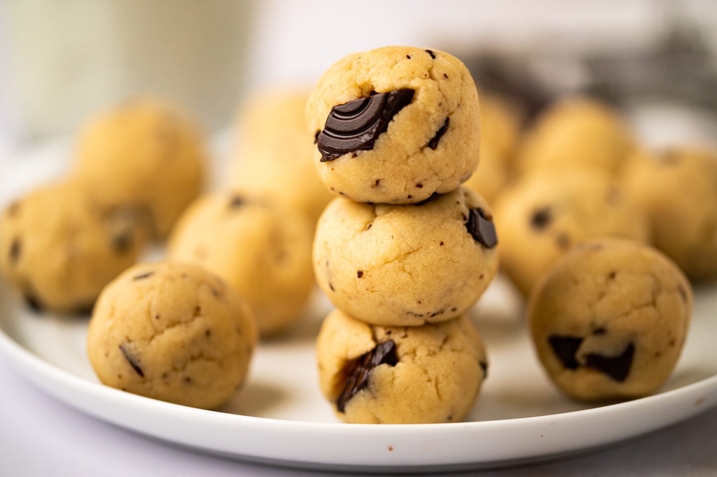 edible chocolate chip cookie dough balls stacked on top of each other.