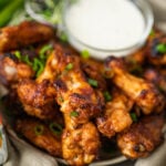 sticky miso wings on a plate with ranch dressing