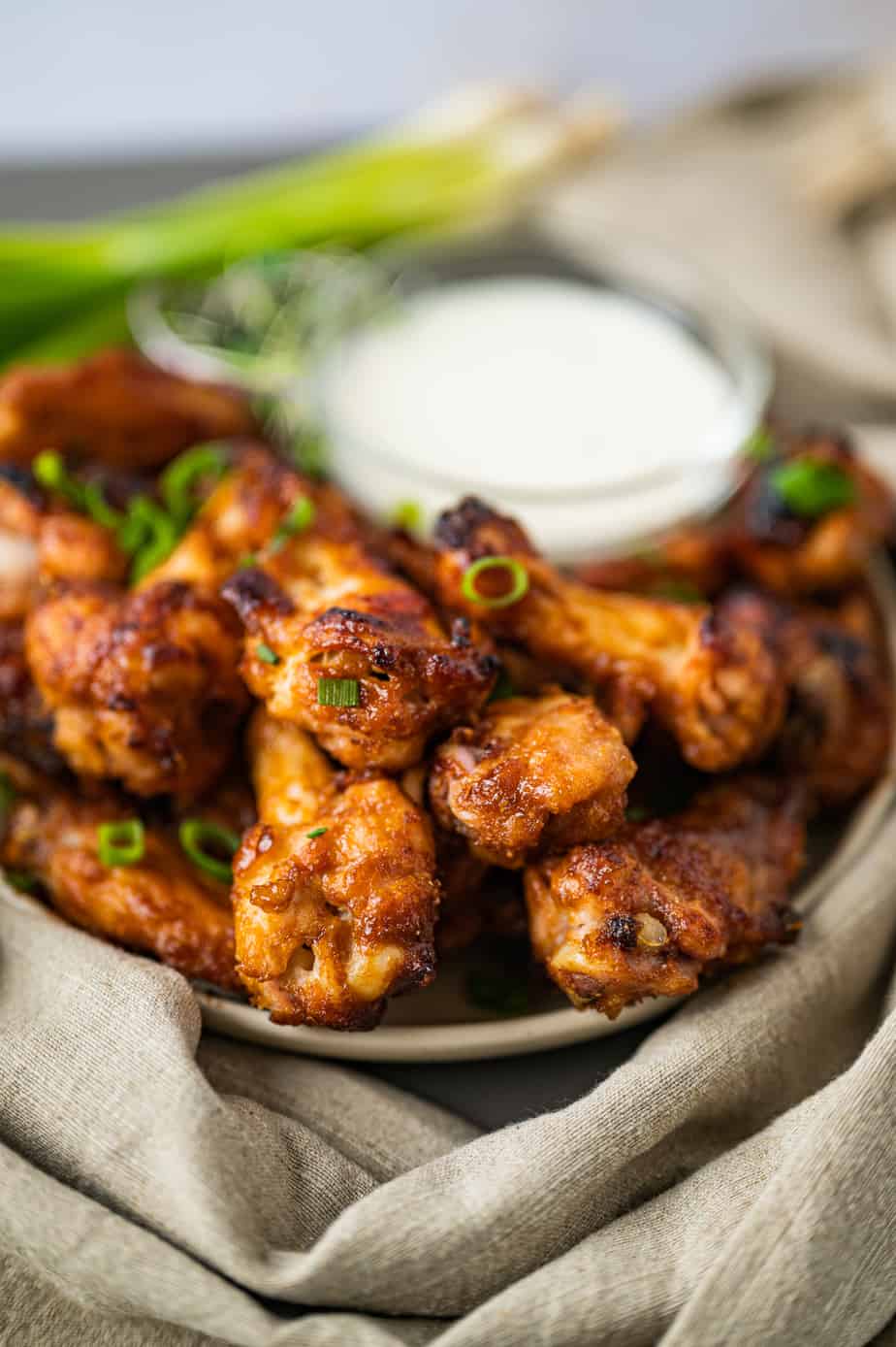 Miso wings on a plate with green onion 