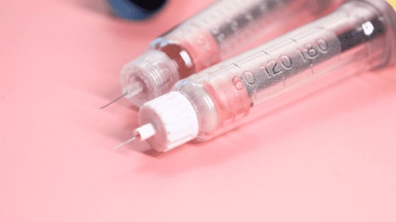 insulin pens lying on pink table
