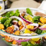 olive garden salad on a wooden table
