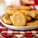 oat nog cookies on a plate surrounded by red and white festive holiday decor