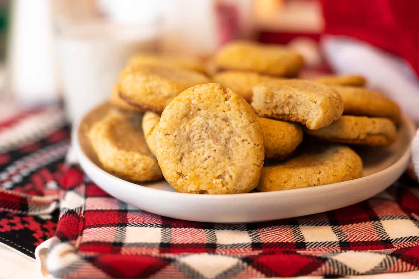 oat nog cookies on a plate surrounded by red and white festive holiday decor