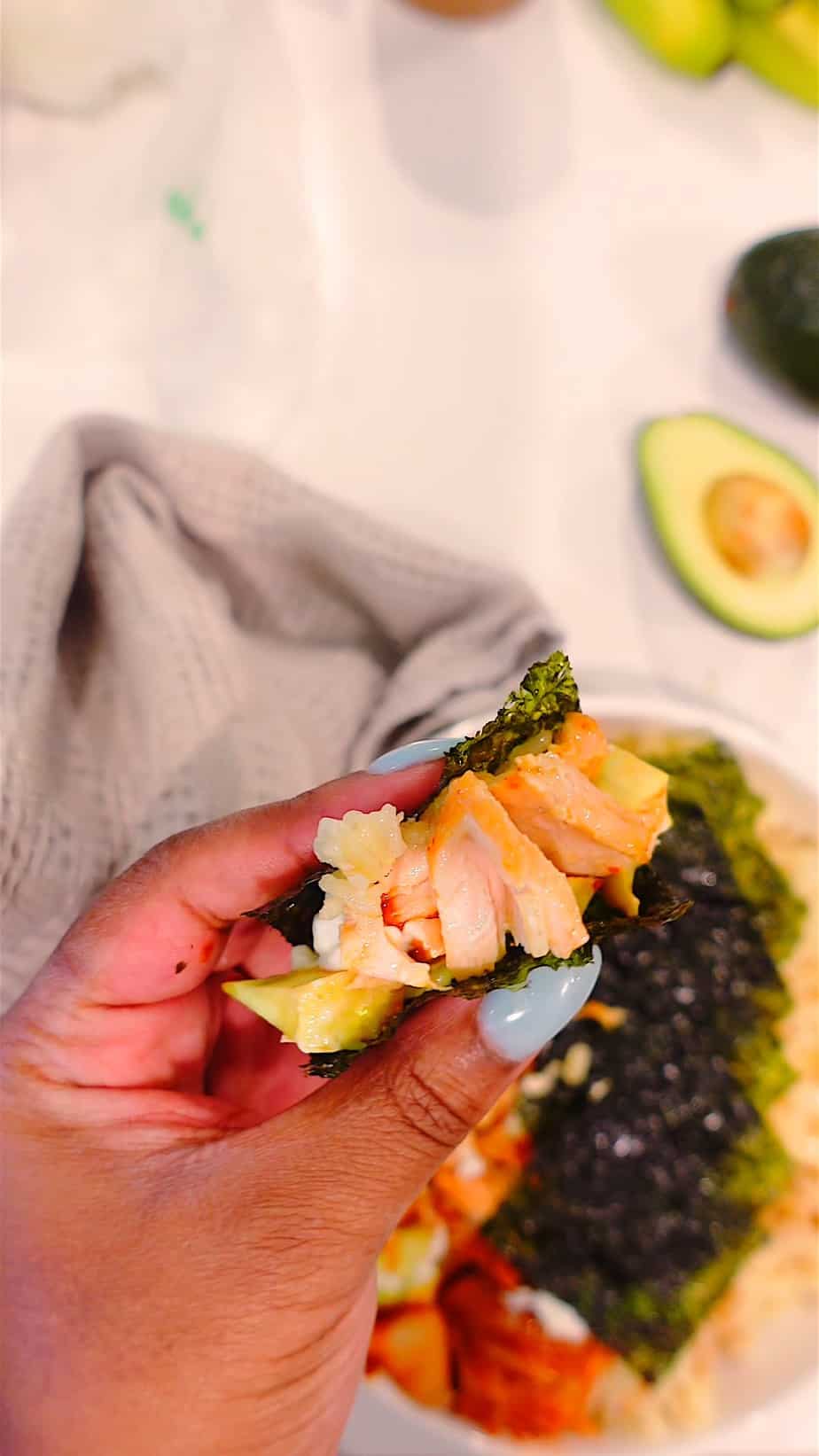 Holding ingredients: salmon and kimchi in nori for a Tiktok salmon rice bowl