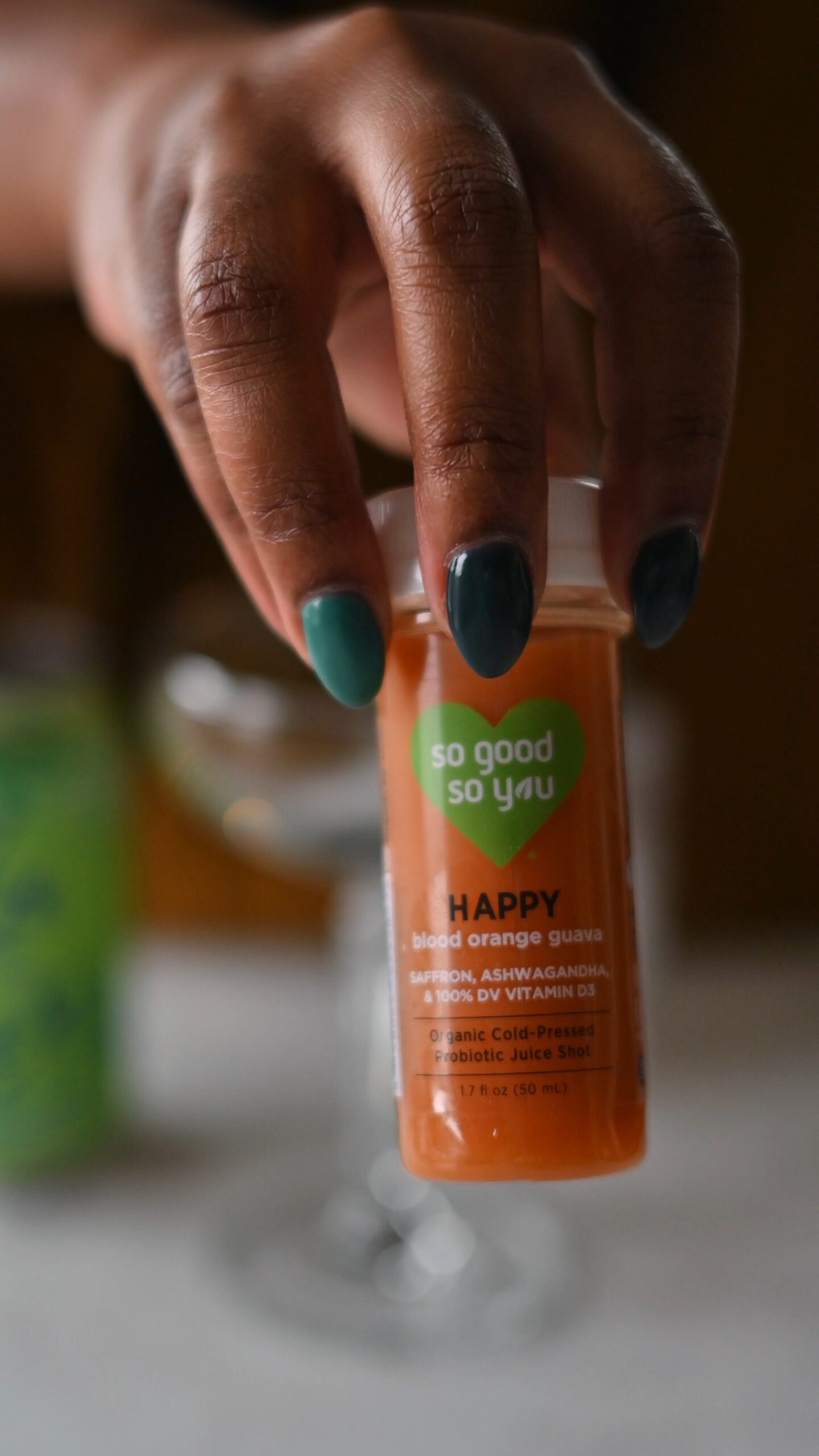 Hands showing off So Good So You Label with orange guava flavor