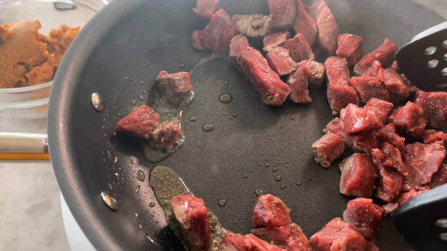 beef being cooked in a non-stick skillet