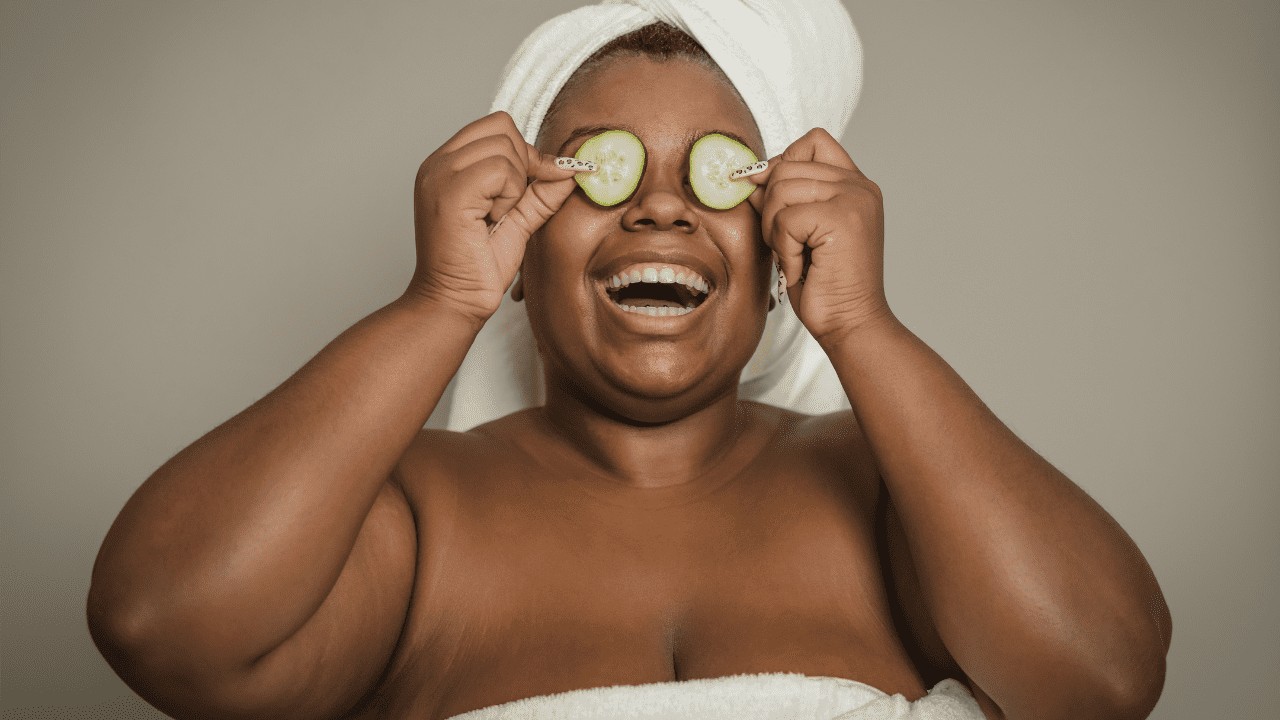 Girl practicing self-care with cucumbers on her eyes