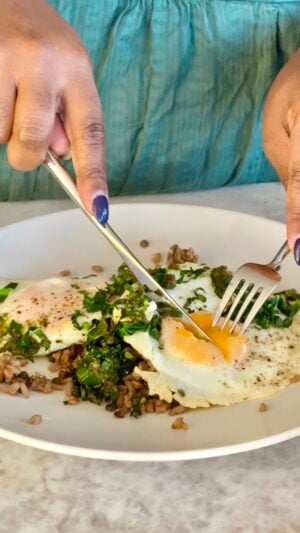 Egg and Pesto Breakfast Grain Bowl cut with a fork and knife