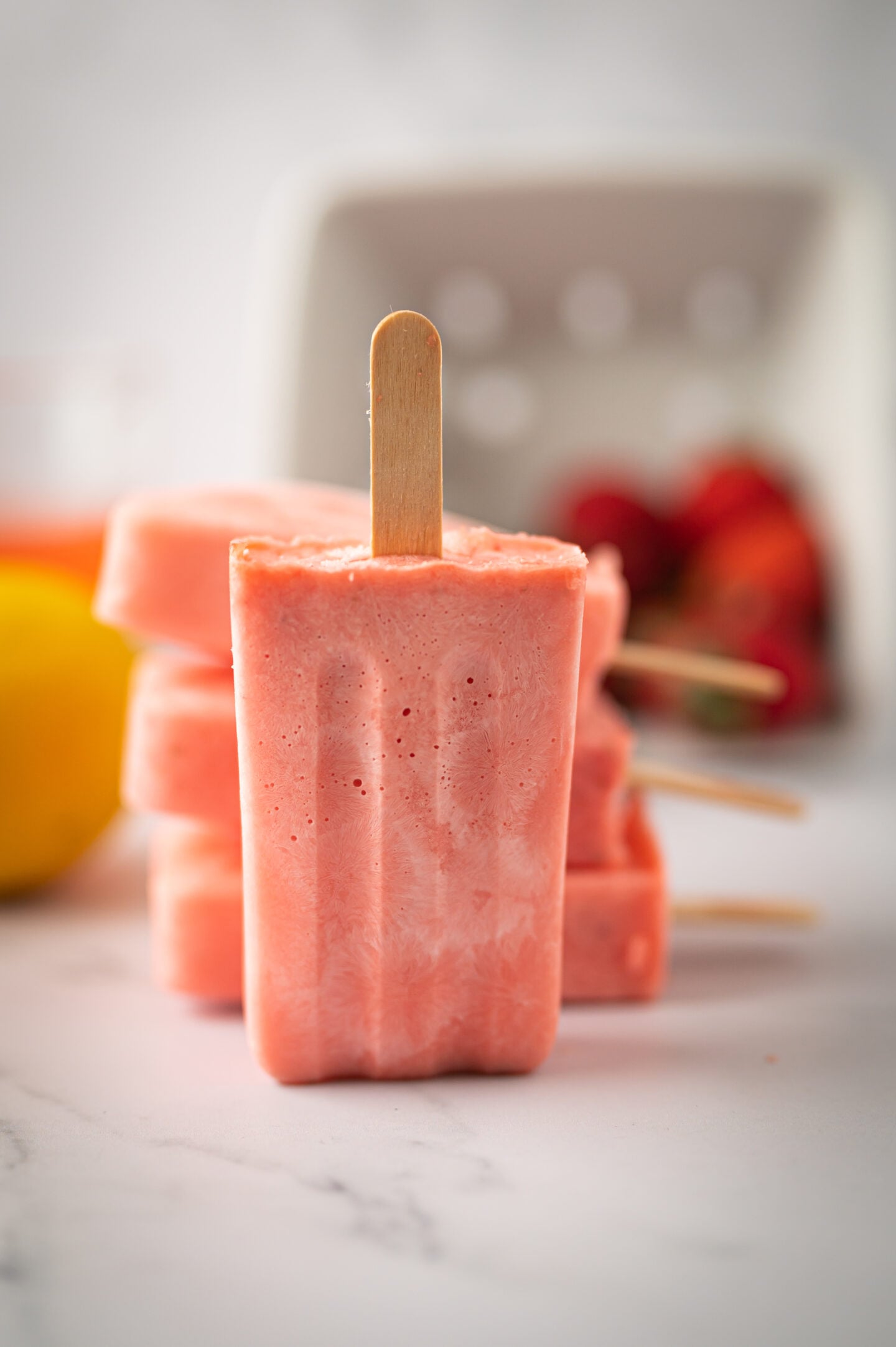 Strawberry lemonade ice pops stacked on top of each other.