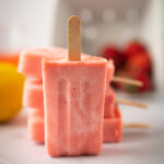 Strawberry lemonade ice pops stacked on top of each other.