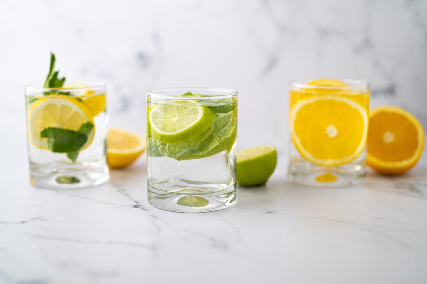 Three infused waters on a marble table.