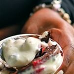 Spoonfull of yogurt with strawberries and chocolate