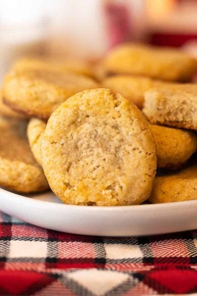 oat nog cookies on a plate surrounded by red and white festive holiday decor